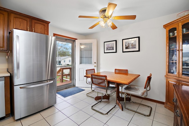 dining area featuring ceiling fan and light tile patterned flooring