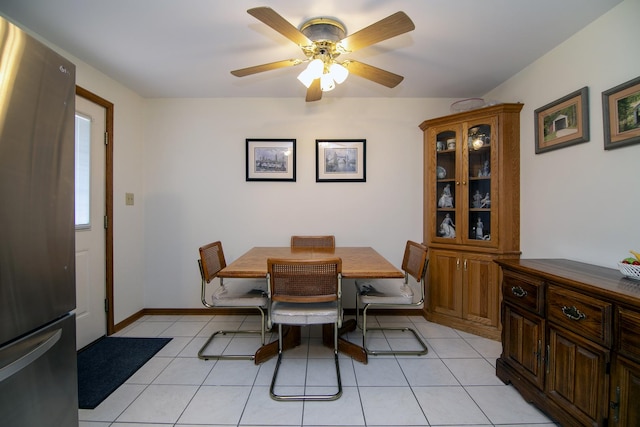 dining room with baseboards, light tile patterned floors, and ceiling fan