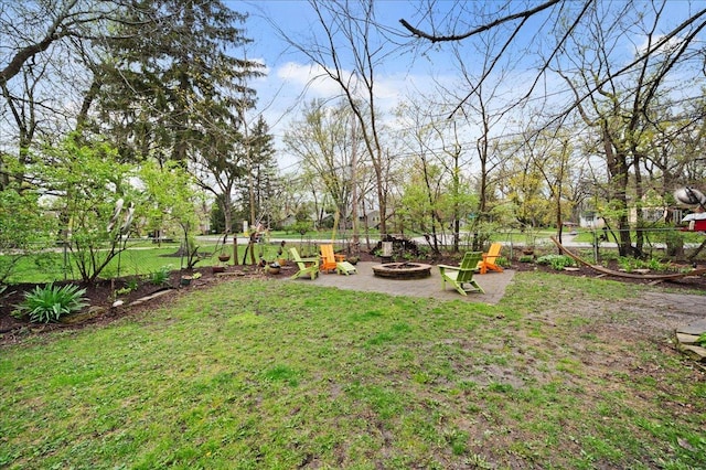 view of yard with a fire pit and fence