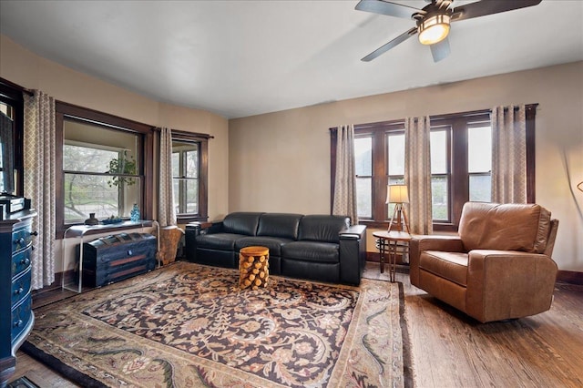 living area featuring ceiling fan and wood finished floors
