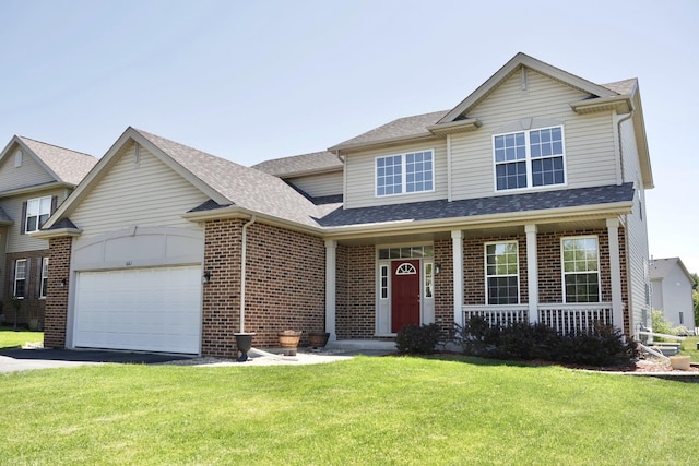 661 Bluebonnett Dr, Aurora, IL 60505 - view of front of property featuring a garage, driveway, brick siding, and a front lawn
