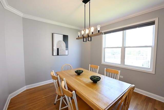 661 Bluebonnett Dr, Aurora, IL 60505 - dining room with baseboards, dark wood-type flooring, crown molding, and a chandelier