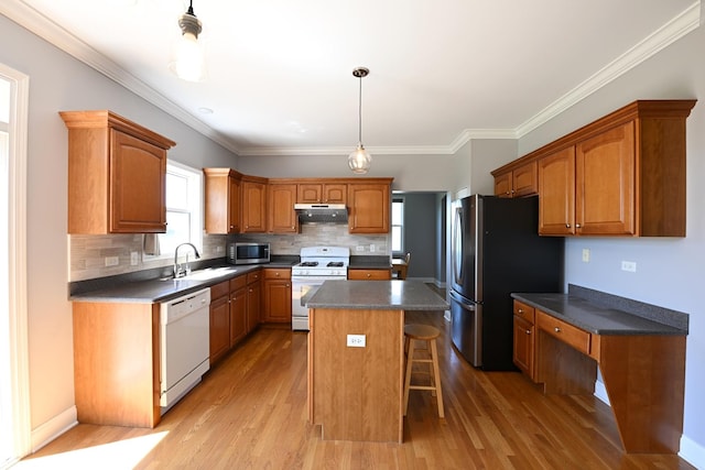 661 Bluebonnett Dr, Aurora, IL 60505 - kitchen featuring stainless steel appliances, under cabinet range hood, a sink, dark countertops, and a center island