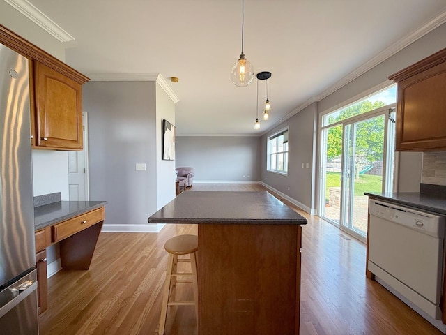 661 Bluebonnett Dr, Aurora, IL 60505 - kitchen featuring white dishwasher, ornamental molding, dark countertops, and freestanding refrigerator