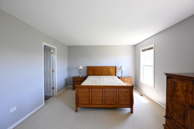 661 Bluebonnett Dr, Aurora, IL 60505 - bedroom featuring baseboards and light colored carpet