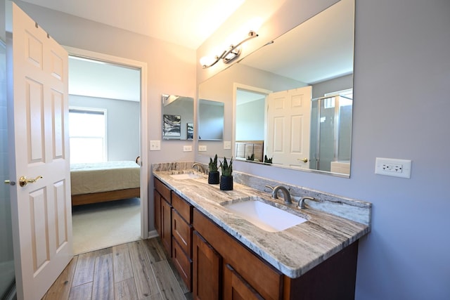 661 Bluebonnett Dr, Aurora, IL 60505 - ensuite bathroom featuring wood finished floors, a shower with shower door, and double vanity