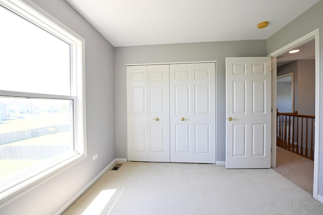 661 Bluebonnett Dr, Aurora, IL 60505 - unfurnished bedroom with light colored carpet, a closet, and baseboards