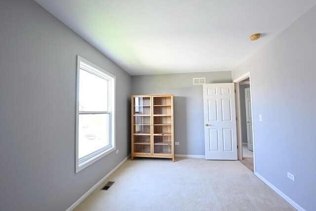 661 Bluebonnett Dr, Aurora, IL 60505 - unfurnished room with a smoke detector, baseboards, and light carpet