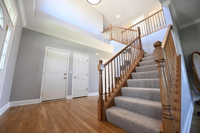 661 Bluebonnett Dr, Aurora, IL 60505 - foyer entrance with stairs, baseboards, wood finished floors, ornamental molding, and a towering ceiling
