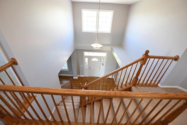 661 Bluebonnett Dr, Aurora, IL 60505 - staircase with plenty of natural light, baseboards, and a towering ceiling