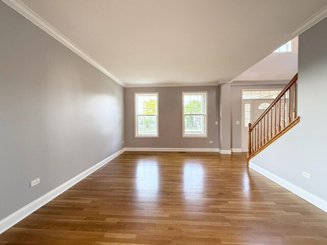 661 Bluebonnett Dr, Aurora, IL 60505 - unfurnished living room with ornamental molding, baseboards, wood finished floors, and stairs