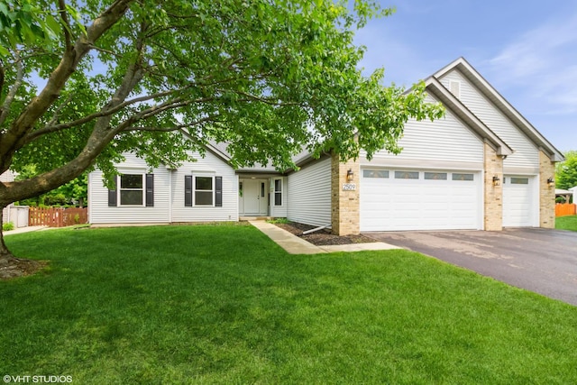 2509 Oak Trails Dr, Aurora, IL 60506 - ranch-style house with asphalt driveway, an attached garage, and brick siding