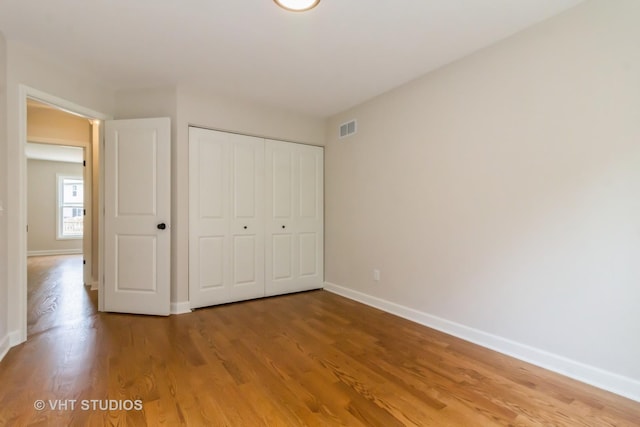 2509 Oak Trails Dr, Aurora, IL 60506 - unfurnished bedroom featuring wood finished floors and a closet