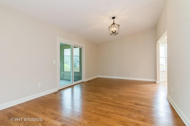 2509 Oak Trails Dr, Aurora, IL 60506 - empty room with a chandelier and light wood-type flooring