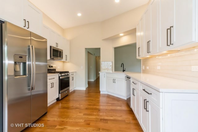 2509 Oak Trails Dr, Aurora, IL 60506 - kitchen with stainless steel appliances, backsplash, white cabinetry, light countertops, and recessed lighting