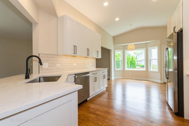 2509 Oak Trails Dr, Aurora, IL 60506 - kitchen featuring stainless steel appliances, decorative backsplash, wood finished floors, white cabinets, and light countertops
