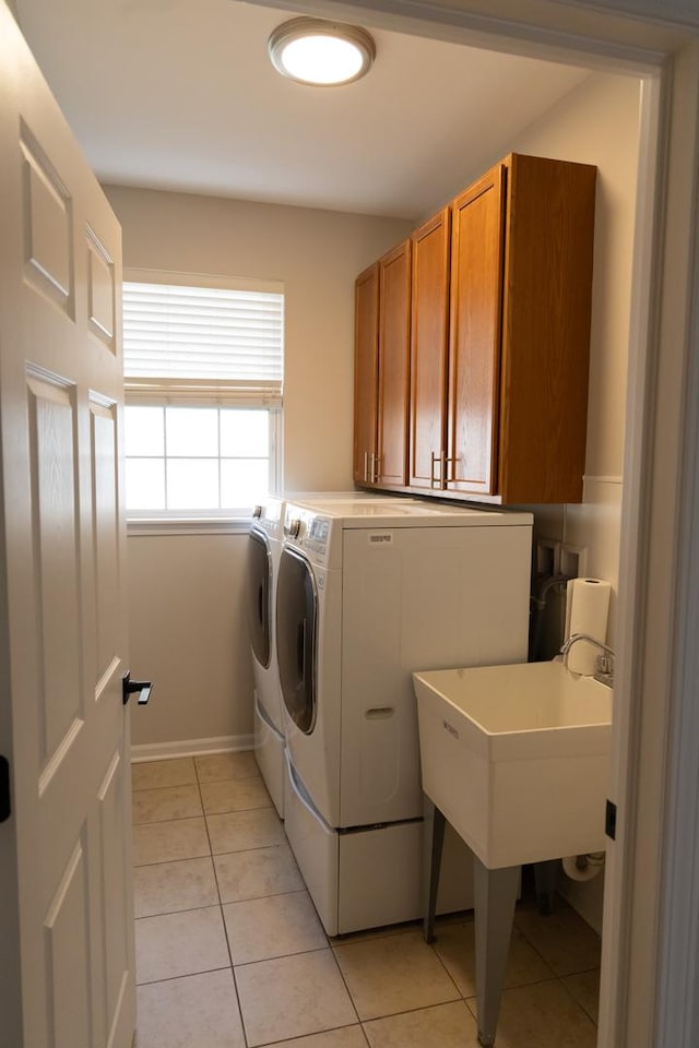 2836 Hillcrest Cir, Naperville, IL 60564 - clothes washing area featuring cabinet space, washing machine and dryer, light tile patterned flooring, and baseboards