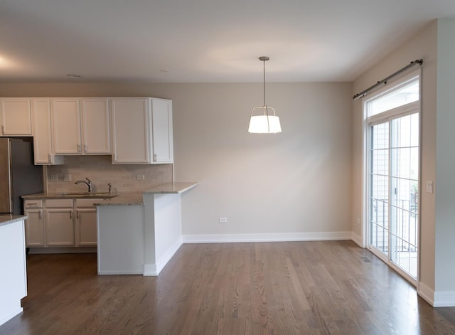 2836 Hillcrest Cir, Naperville, IL 60564 - kitchen featuring freestanding refrigerator, a sink, white cabinets, tasteful backsplash, and dark wood-style floors