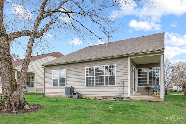 204 Fairwind Dr, Montgomery, IL 60538 - back of house featuring a lawn and central AC unit