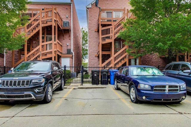 1473 N Larrabee St Unit A, Chicago, IL 60610 - view of building exterior with stairs and uncovered parking