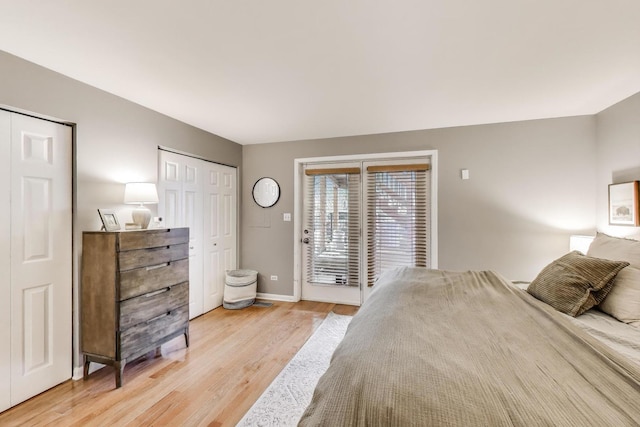 1473 N Larrabee St Unit A, Chicago, IL 60610 - bedroom featuring access to exterior, light wood-type flooring, multiple closets, and baseboards