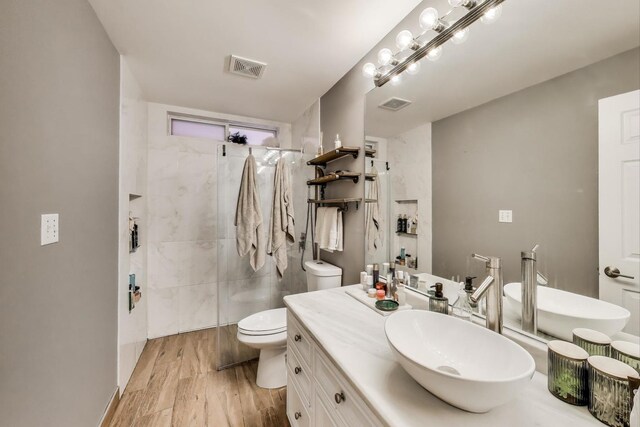 1473 N Larrabee St Unit A, Chicago, IL 60610 - full bathroom with toilet, vanity, a tile shower, and wood finished floors