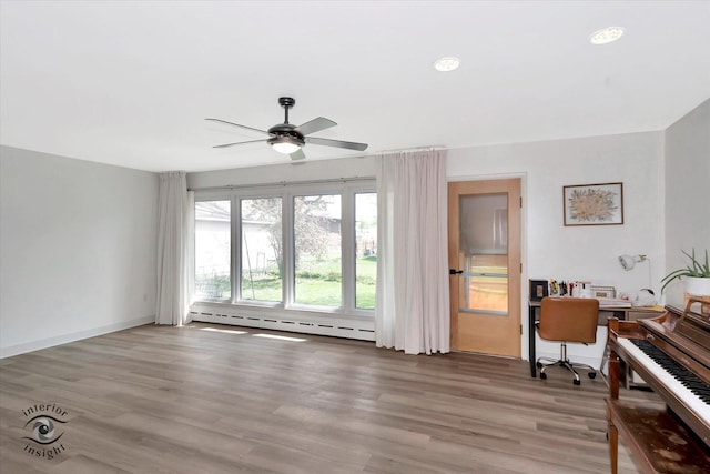 interior space with ceiling fan, wood finished floors, baseboards, a baseboard radiator, and recessed lighting