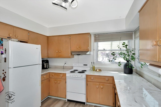 kitchen with light countertops, under cabinet range hood, and white appliances
