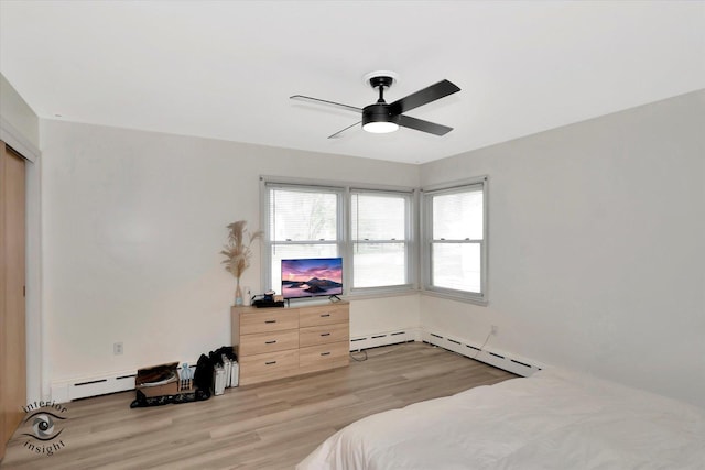 bedroom with light wood-type flooring, a ceiling fan, and baseboard heating