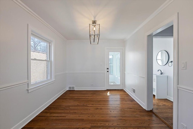7241 N Kilpatrick Ave, Lincolnwood, IL 60712 - foyer entrance featuring baseboards, ornamental molding, dark wood-type flooring, and visible vents
