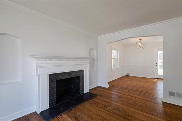 7241 N Kilpatrick Ave, Lincolnwood, IL 60712 - unfurnished living room with ornamental molding, wood finished floors, visible vents, and a fireplace
