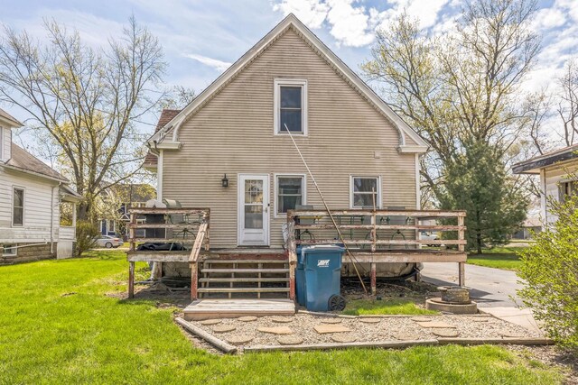 back of property with a wooden deck, a lawn, and a chimney