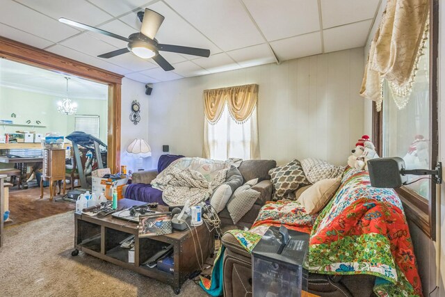 living room with carpet flooring, a ceiling fan, and a drop ceiling