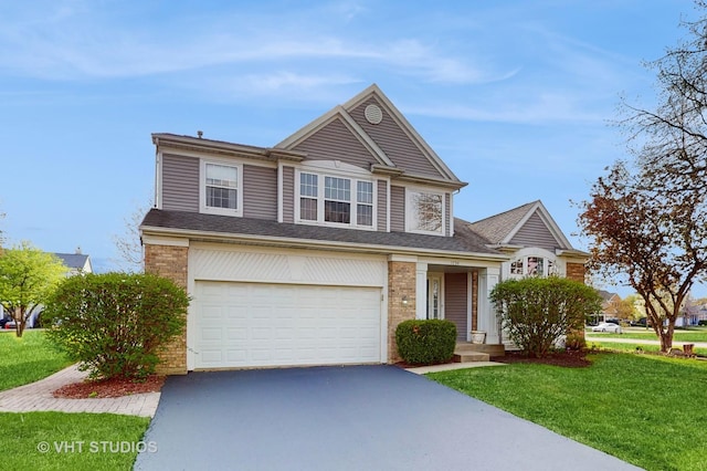 1734 Nashville Ln, Crystal Lake, IL 60014 - view of front of home with brick siding, a garage, a front lawn, and driveway
