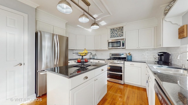 1734 Nashville Ln, Crystal Lake, IL 60014 - kitchen with a kitchen island, white cabinetry, a sink, backsplash, and stainless steel appliances