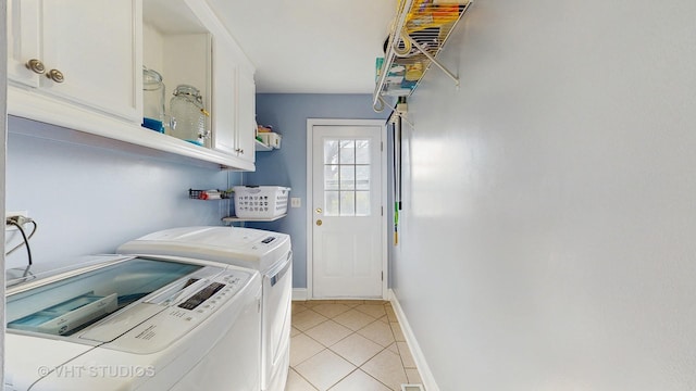 1734 Nashville Ln, Crystal Lake, IL 60014 - washroom with baseboards, cabinet space, light tile patterned floors, and washing machine and clothes dryer