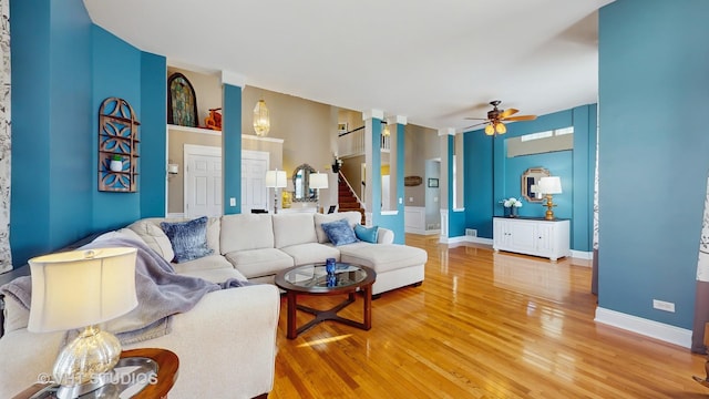 1734 Nashville Ln, Crystal Lake, IL 60014 - living room featuring light wood-style floors, baseboards, ceiling fan, and stairway