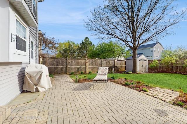 1734 Nashville Ln, Crystal Lake, IL 60014 - view of patio with a fenced backyard, an outbuilding, a storage shed, and grilling area