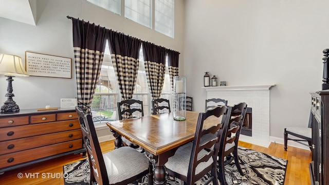 1734 Nashville Ln, Crystal Lake, IL 60014 - dining area featuring baseboards, wood finished floors, a high ceiling, and a fireplace