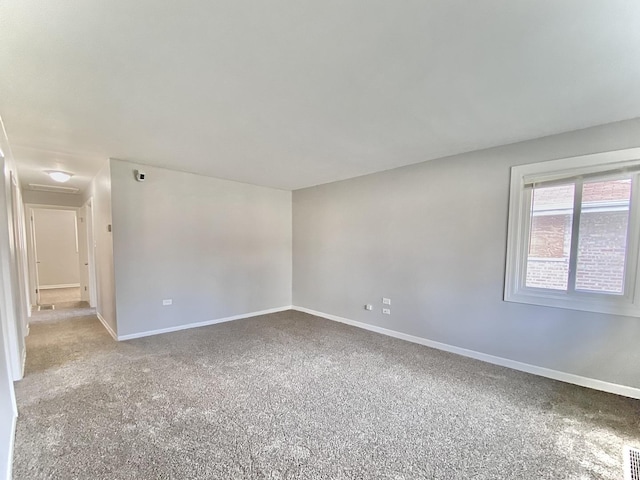 unfurnished room with light carpet and baseboards