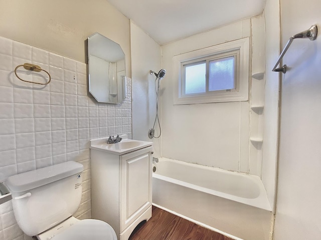 bathroom featuring toilet, tile walls, shower / bathtub combination, wood finished floors, and vanity