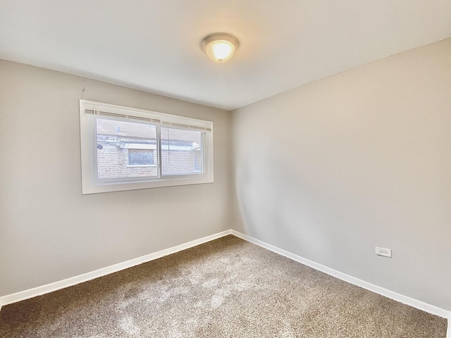 carpeted empty room with baseboards
