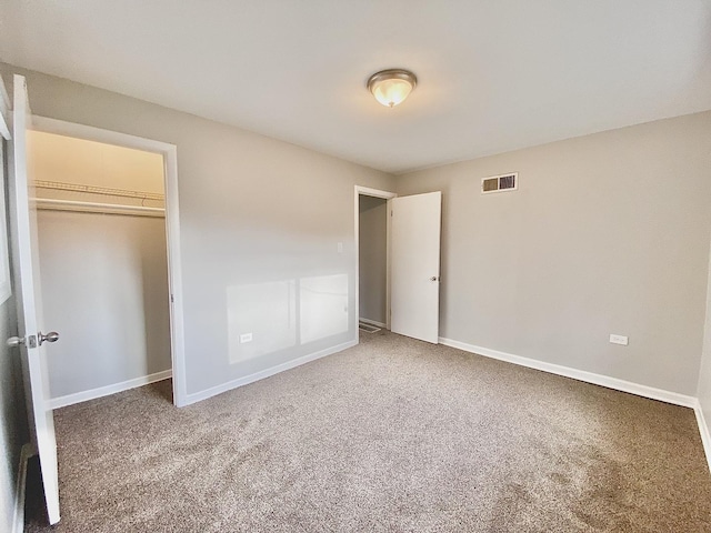 unfurnished bedroom featuring baseboards, a closet, visible vents, and carpet