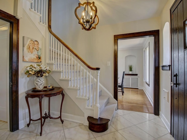 517 S Washington St, Wheaton, IL 60187 - foyer entrance with arched walkways, stairway, ornamental molding, and light tile patterned floors