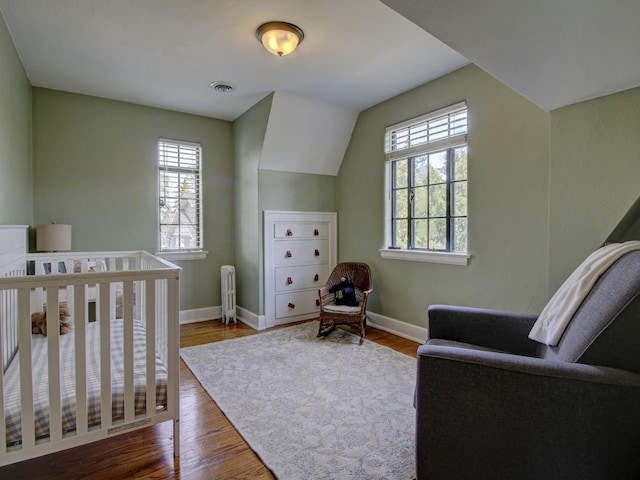517 S Washington St, Wheaton, IL 60187 - bedroom with radiator, wood finished floors, baseboards, and multiple windows