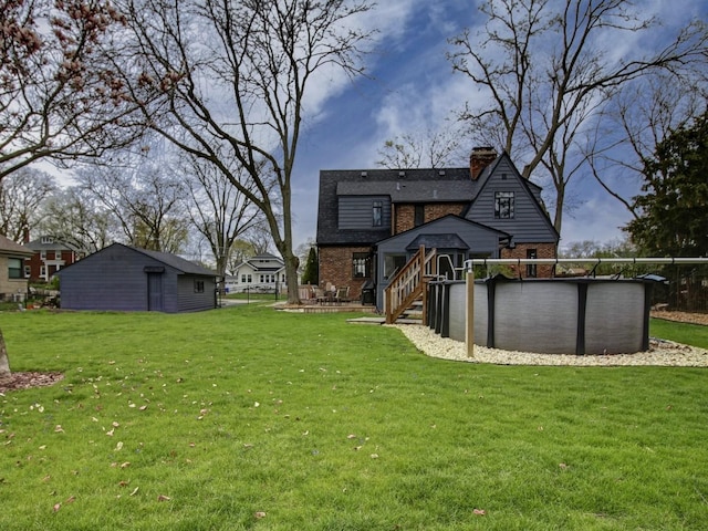 517 S Washington St, Wheaton, IL 60187 - back of property with brick siding, an outdoor pool, a chimney, and a yard
