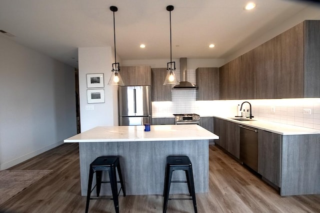 117 S Bell Ave Unit 4S, Chicago, IL 60612 - kitchen with modern cabinets, a sink, wall chimney exhaust hood, a kitchen island, and appliances with stainless steel finishes