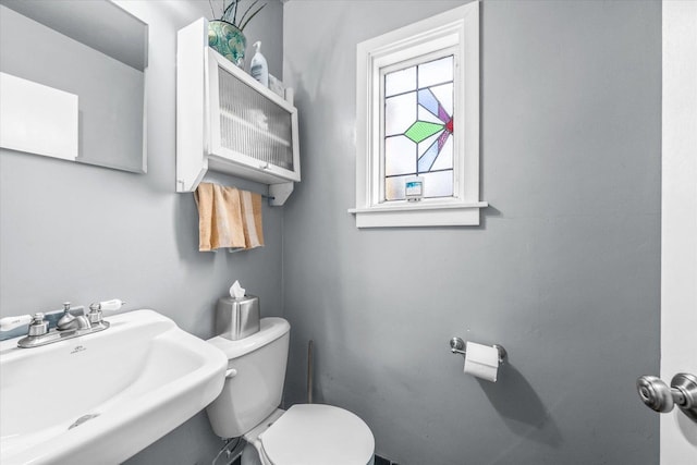 half bathroom with a sink and toilet