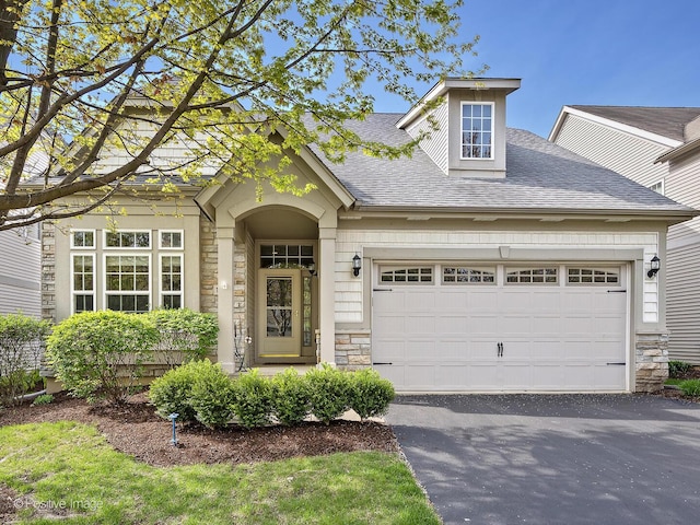 1683 Briarheath Dr, Aurora, IL 60505 - view of front facade with an attached garage, a shingled roof, driveway, and stone siding