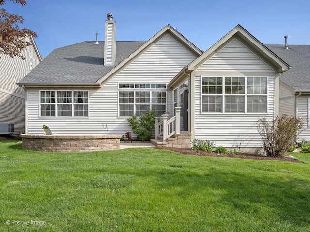 1683 Briarheath Dr, Aurora, IL 60505 - rear view of property featuring a lawn, a chimney, a shingled roof, and entry steps